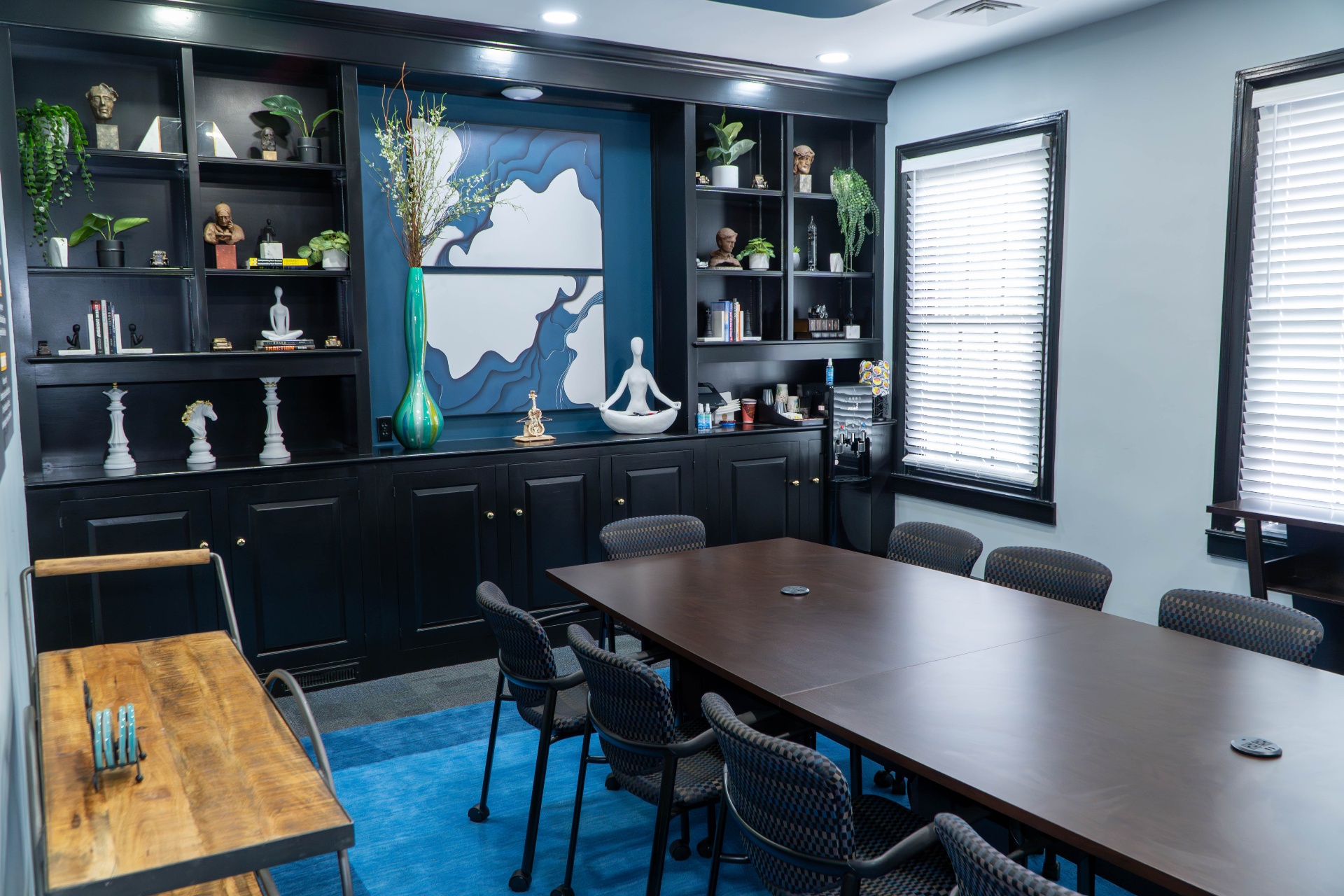 Conference room with custom black built-ins and teal accent wall