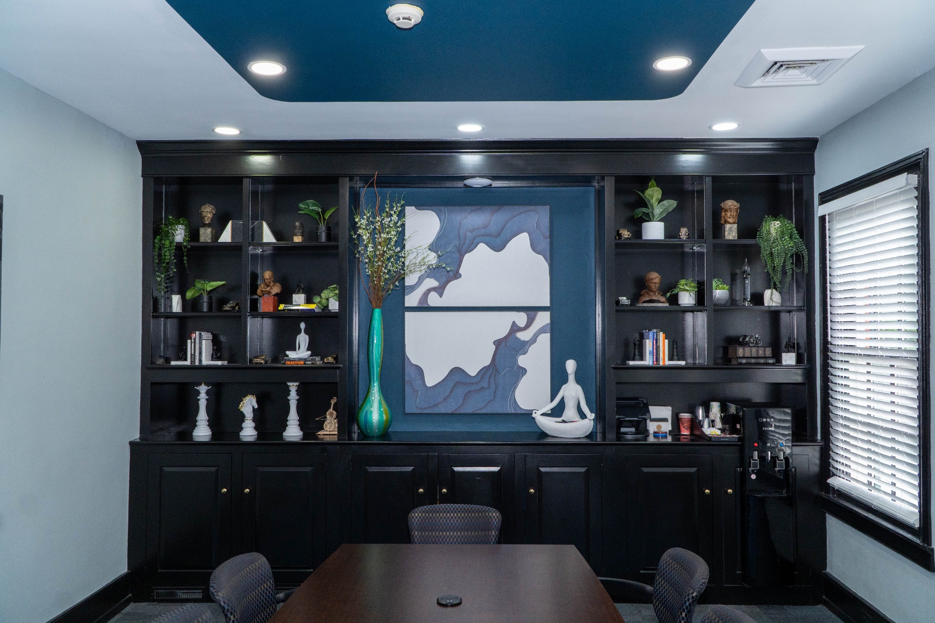 Centered view of feature wall with custom artwork and styled shelving