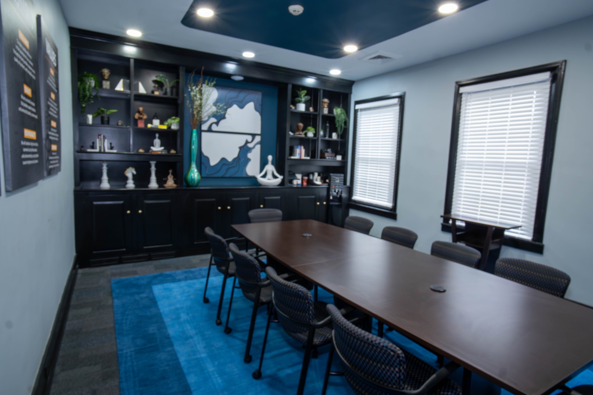 Boardroom showing full length of table and bookcase wall