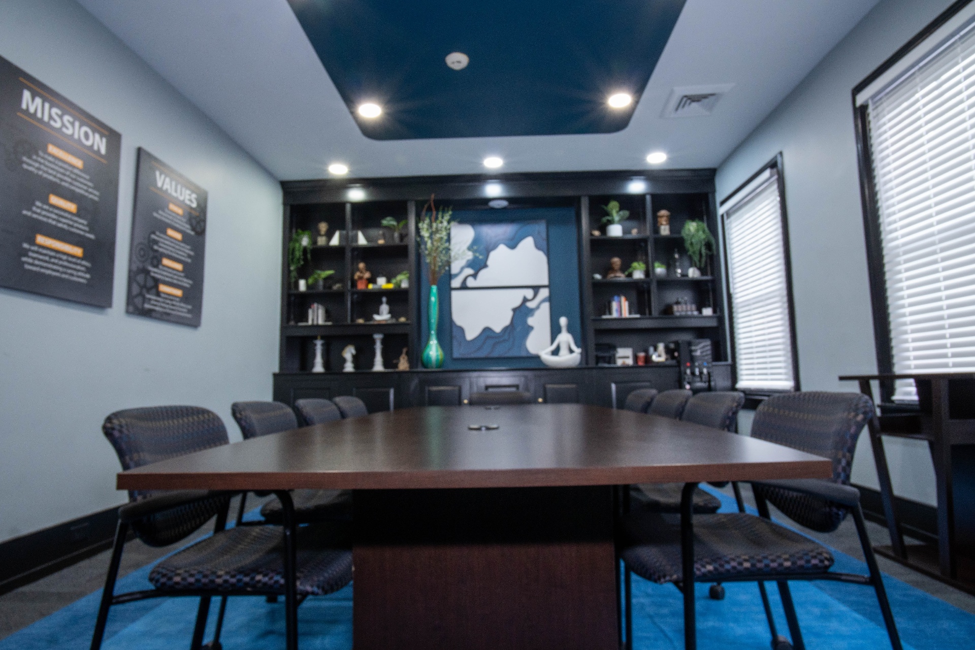 Conference room with mission and values panels and tray ceiling
