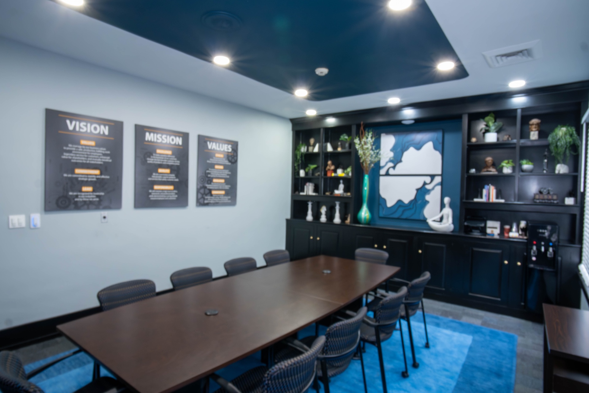 Wide view of conference room with vision, mission, and values wall