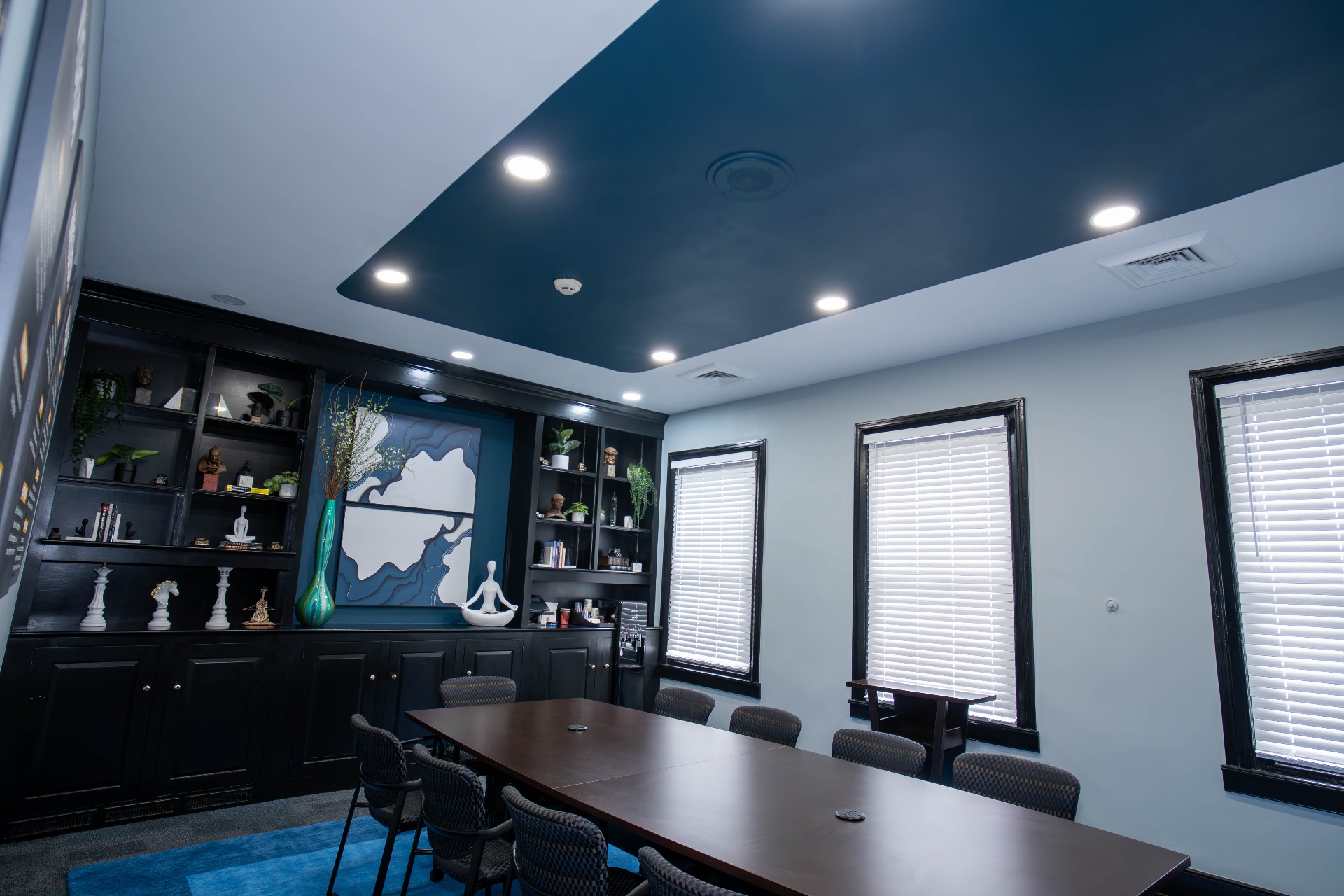 Angled view highlighting the deep teal tray ceiling and built-ins
