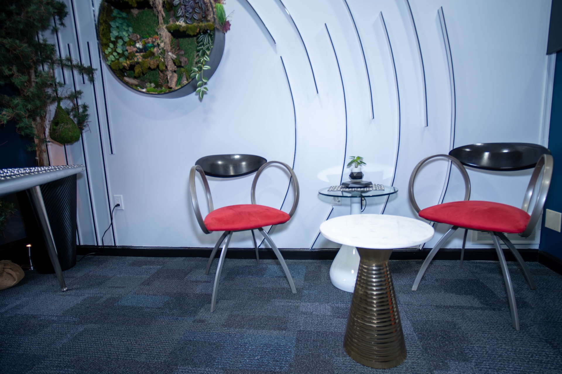 Lounge seating area with bonsai and marble side tables