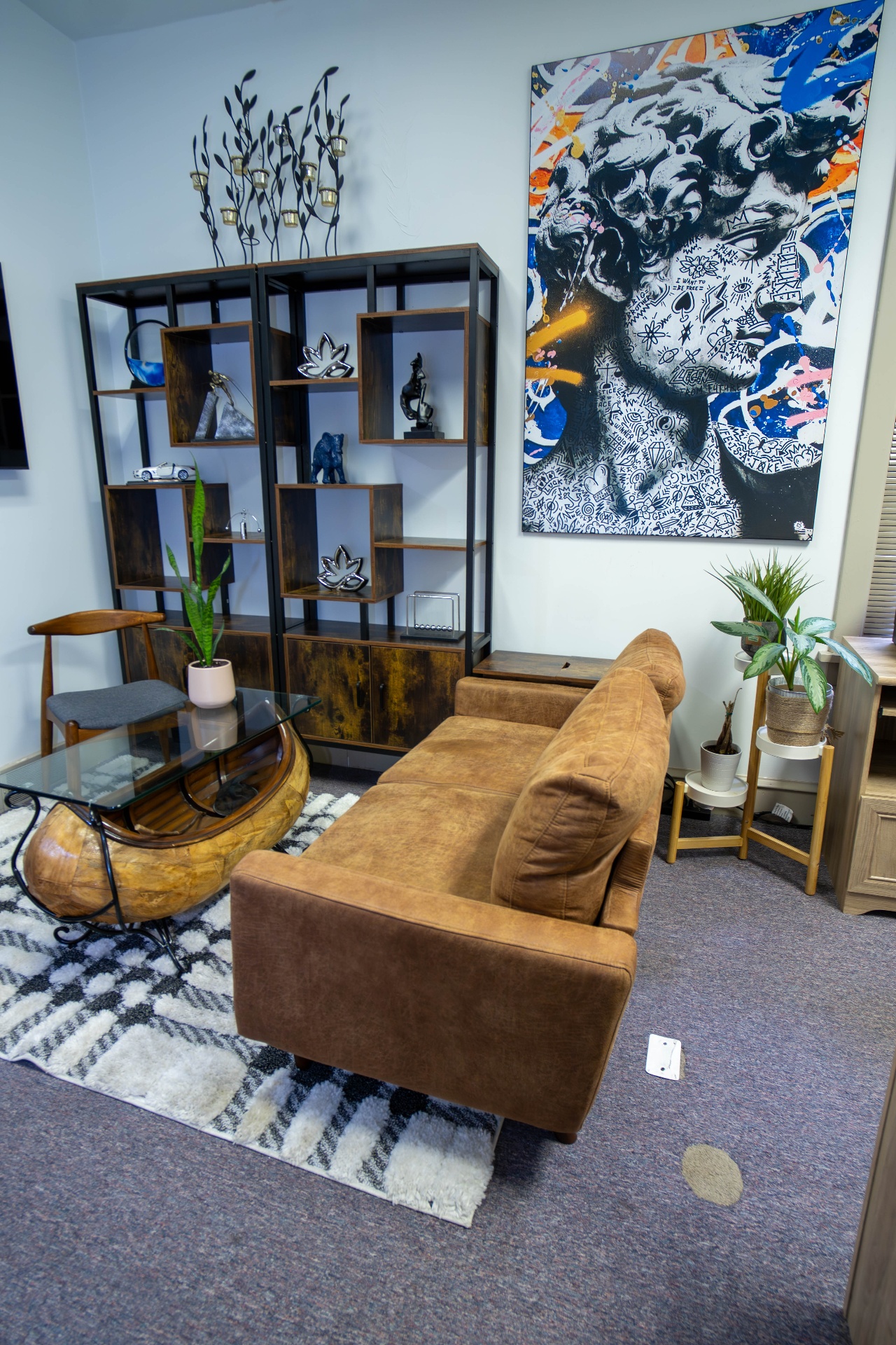 Lounge seating with bookcase styling and large statement artwork