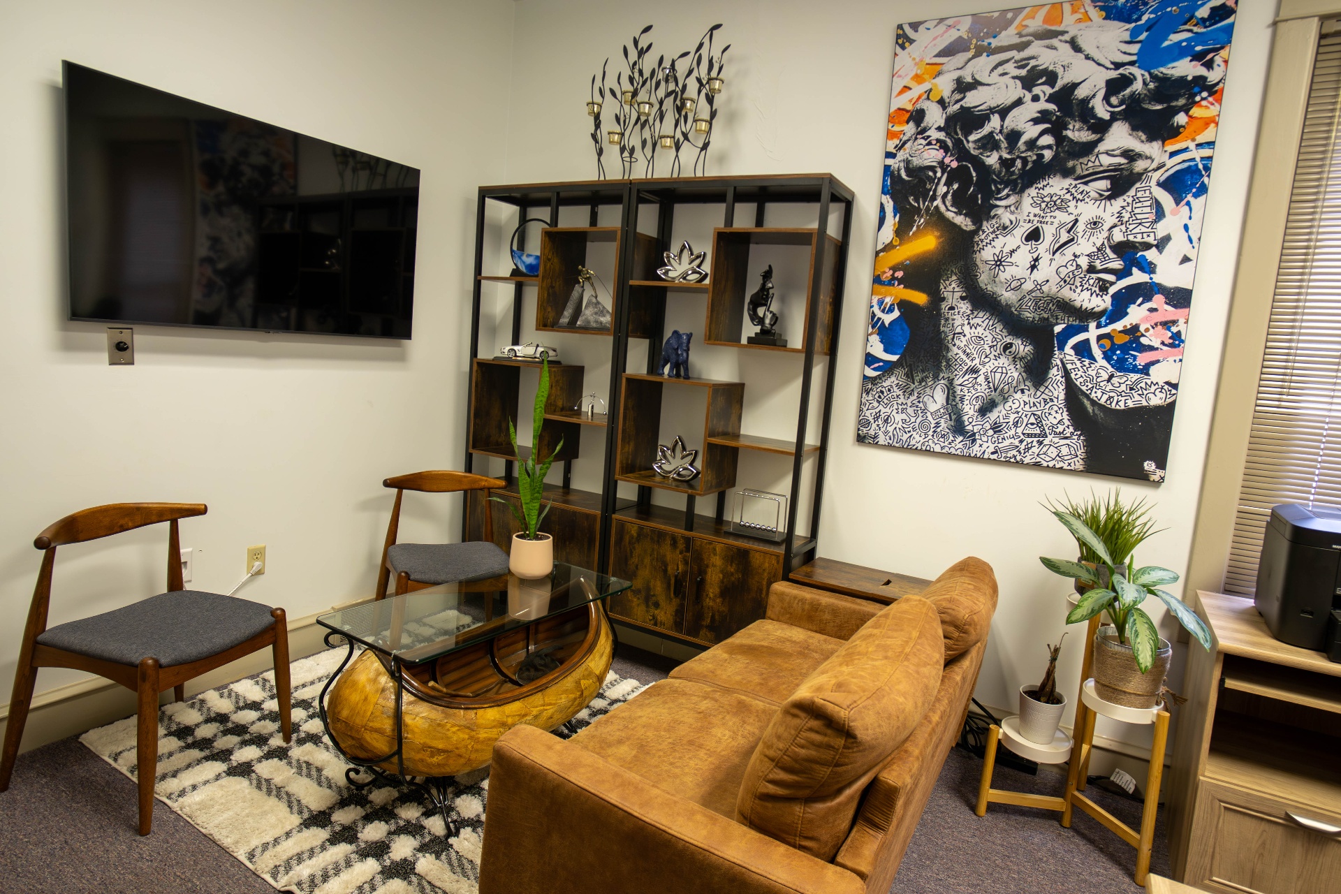 Lounge from the doorway with paired mid-century chairs and statement art