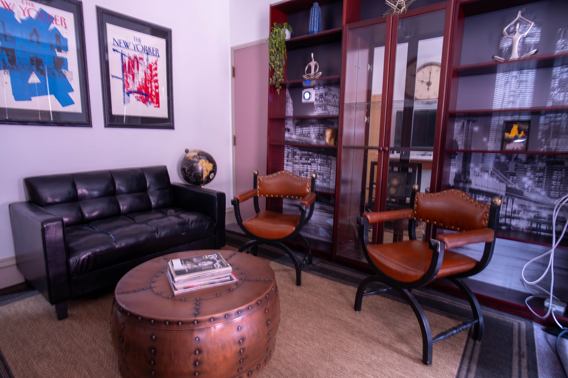 New Yorker-inspired sitting room with leather sofa and curule chairs