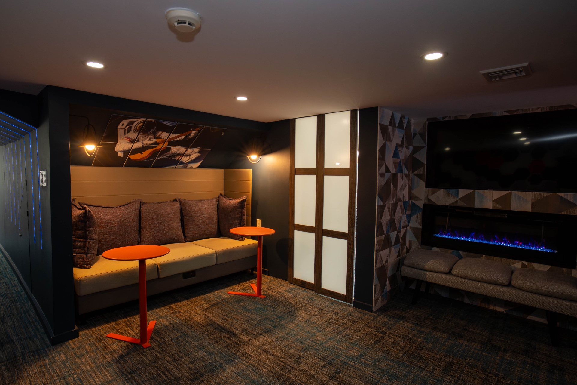 Astronaut mural lounge with banquette seating and dual fireplaces